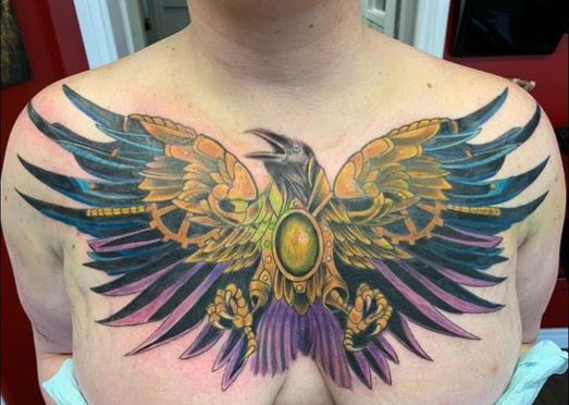 colourful crow chest tattoo