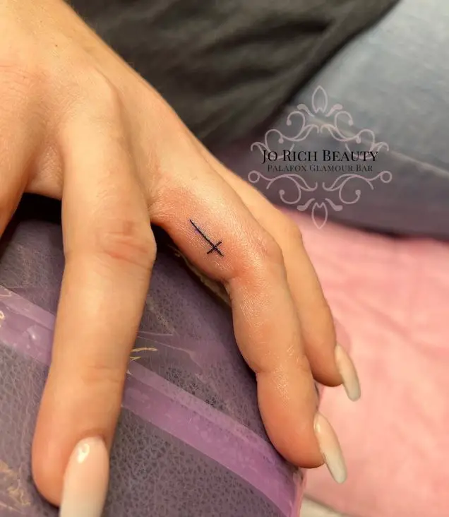 cross tattoo on the finger