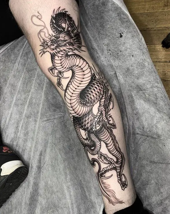dark japanese dragon tattoo on the leg