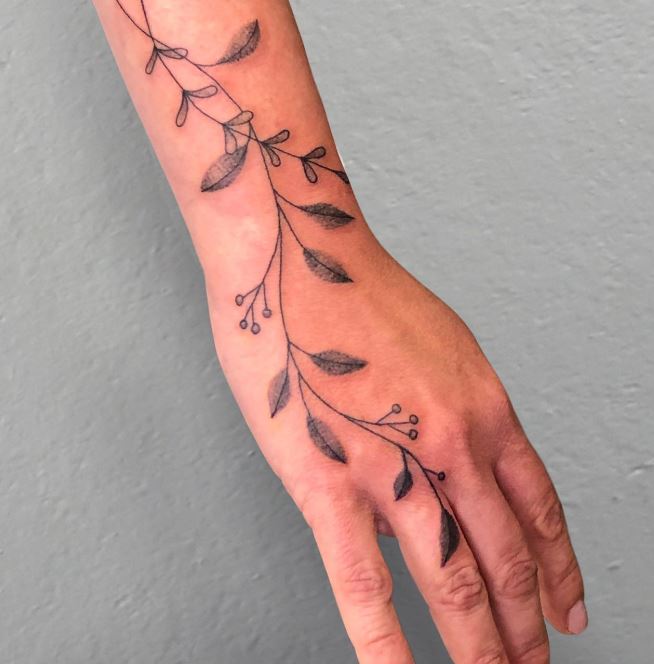 delicate fine line hand tattoo
