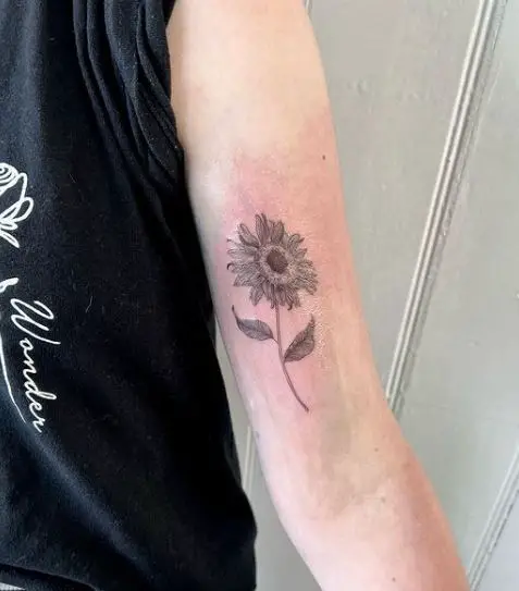 delicate sunflower tattoo on the hand