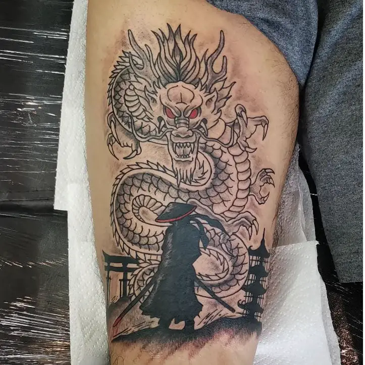 dragon thigh tattoo in black