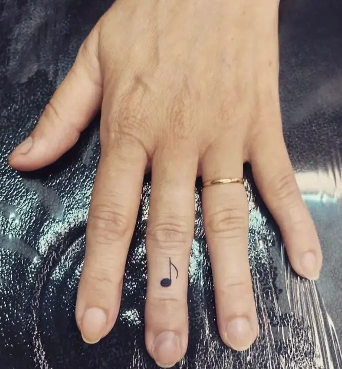 fine line music finger tattoo