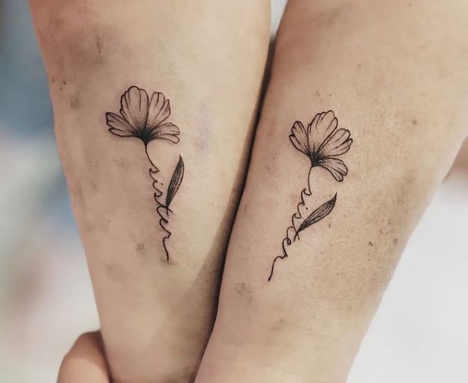floral and wording sisters tattoos