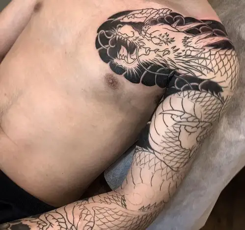 half done dragon tattoo on the shoulder