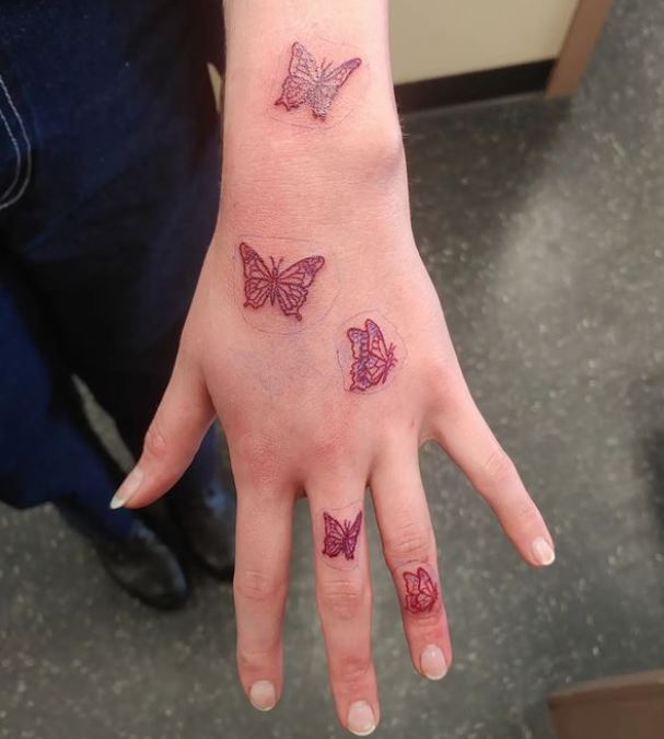 hand tattoo with 5 butterflies