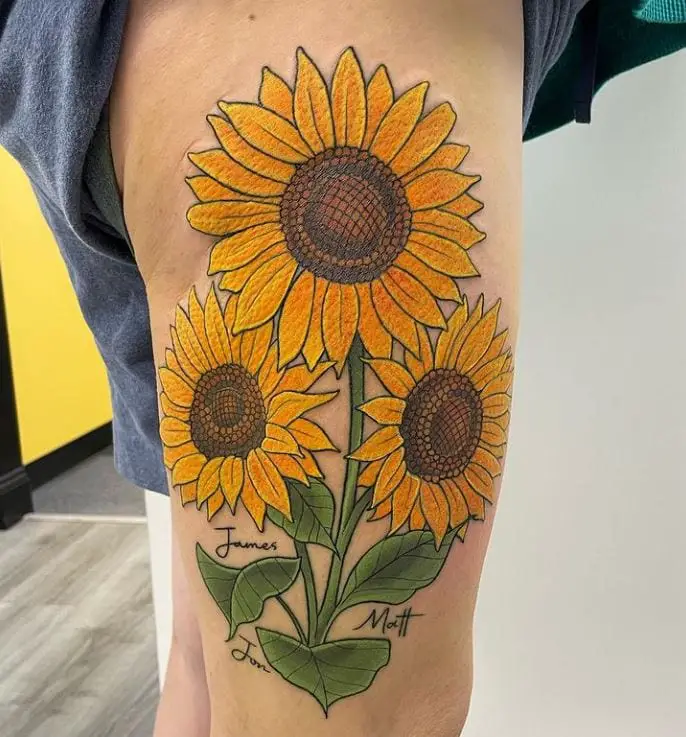 large coloured sunflower tattoo on the leg