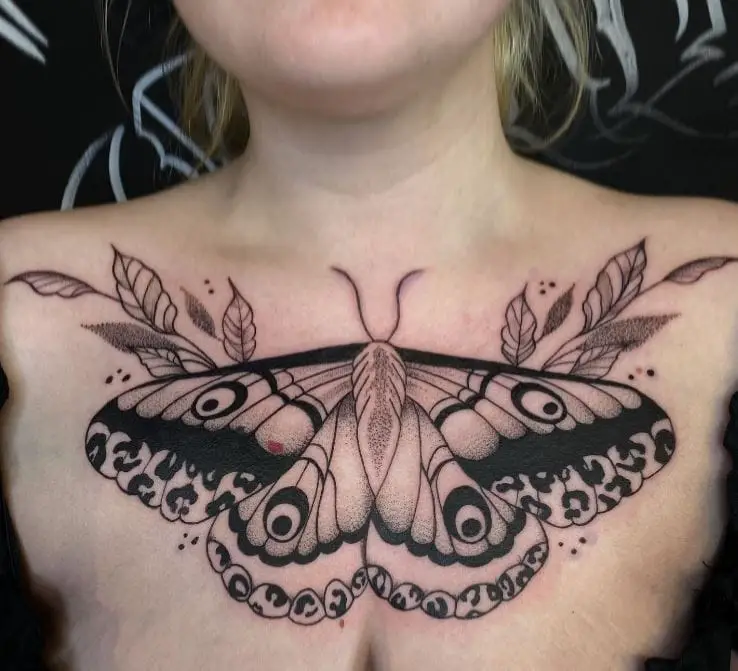 large moth tattoo on the chest
