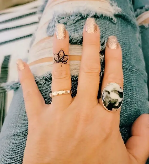 lotus flower tattoo on the finger