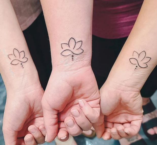 matching lotus tattoos on the wrists