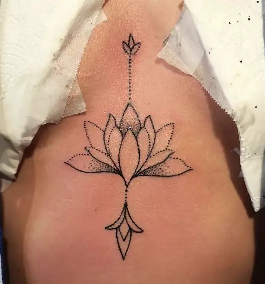 minimal lotus chest tattoo