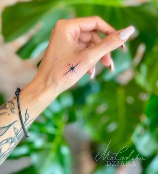 minimal star hand tattoo