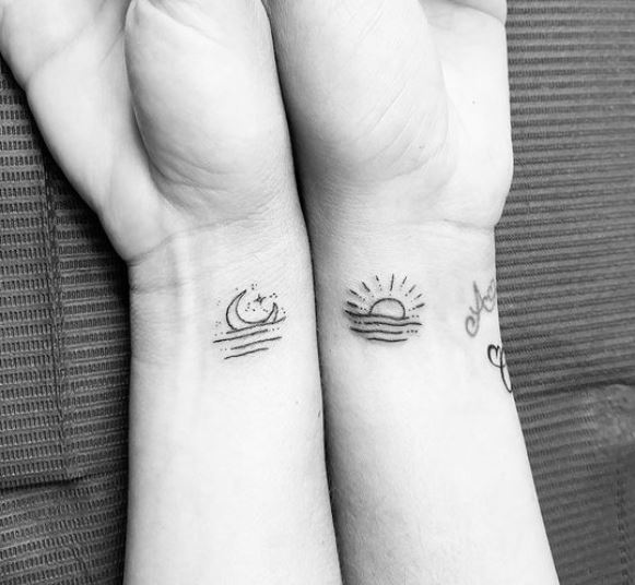 minimalistic sun and moon sister tattoos