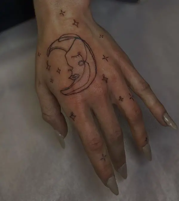 simple moon and stars hand tattoo