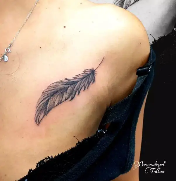 small feather chest tattoo