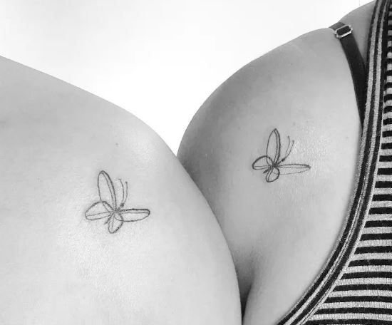 small matching butterfly tattoos on the shoulder