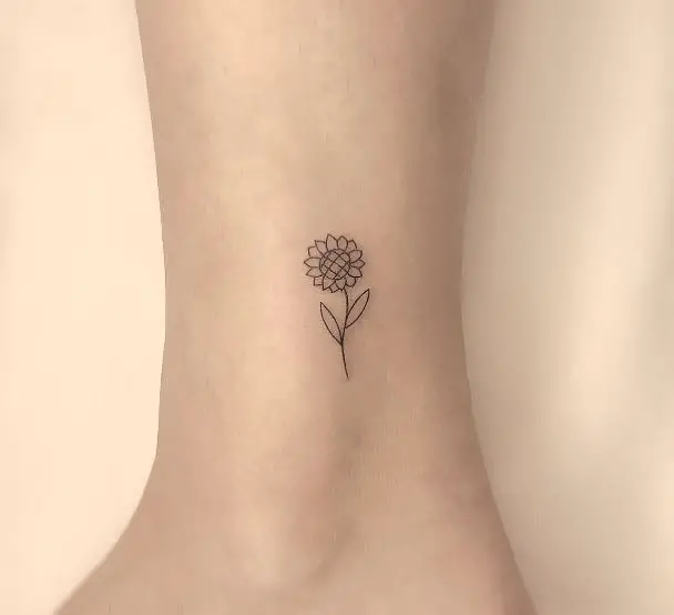 small sunflower tattoo above the ankle