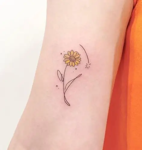 small sunflower tattoo with a bit of yellow