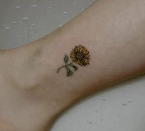 small sunflower tattoo with black outline