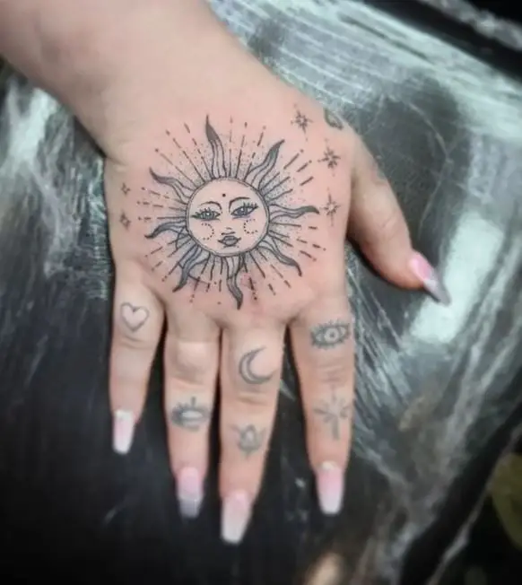 sun hand tattoo in black