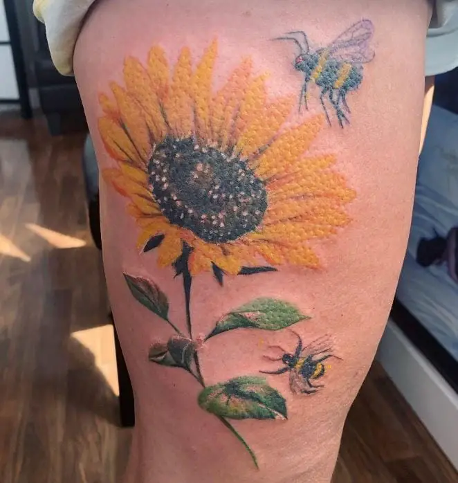 sunflower and bee tattoo on the thigh