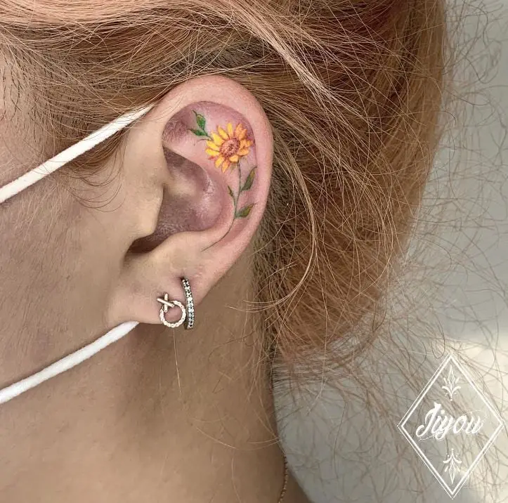 sunflower tattoo inside the ear