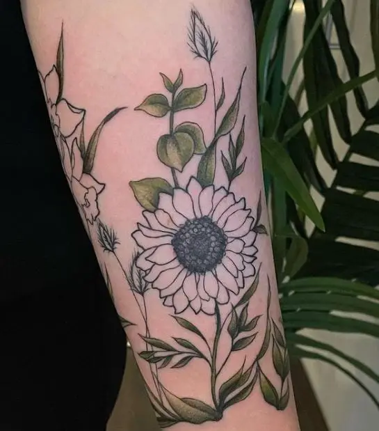 sunflower tattoo with coloured leaves