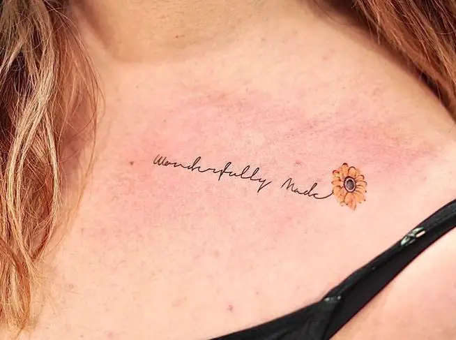 sunflower tattoo with wording on the shoulder