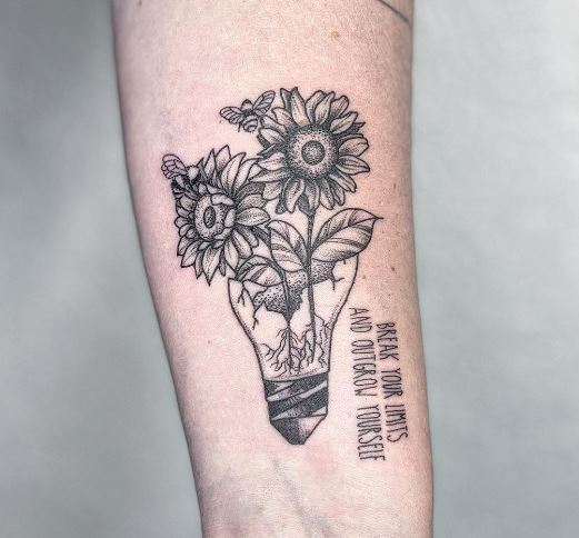 tattoo with a bulb sunflowers, a skull, and a phrase