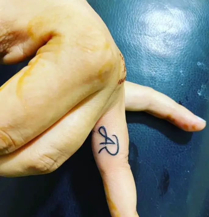 tattoo with initials on the finger