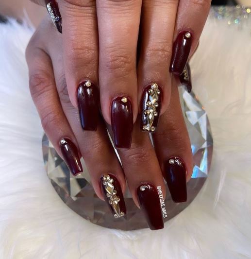 Burgundy Nails With Gold Stones