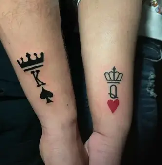 One line chess queen tattoo located on the inner arm.