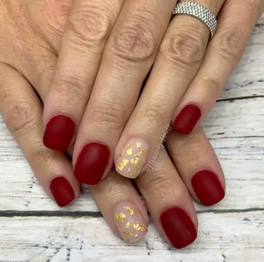 Maroon Nails With Gold Flakes Accent