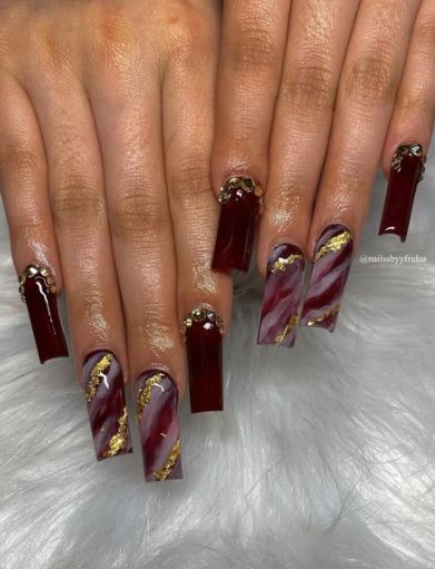 Wavy Maroon and Gold Nail Art