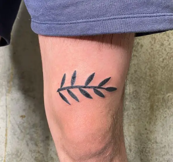 Olive branch tattoo on thighs