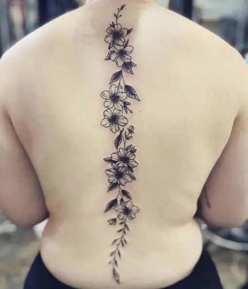 Black Flowers and Leaves Spine Tattoo