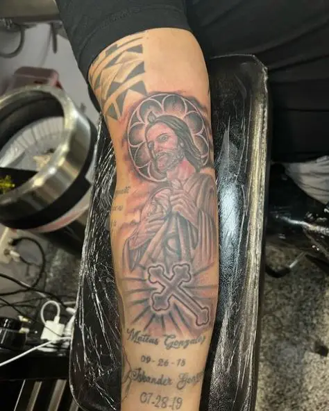 Glowing Cross and San Judas Arm Tattoo