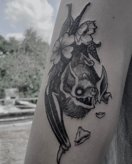 Flowers and Vampire Bat Biceps Tattoo
