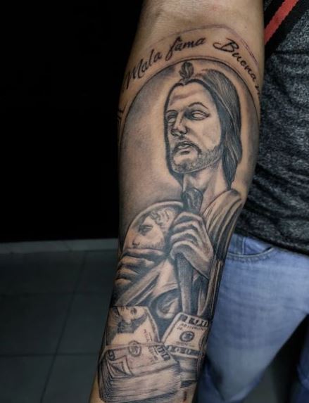 Dollars and San Judas Forearm Tattoo