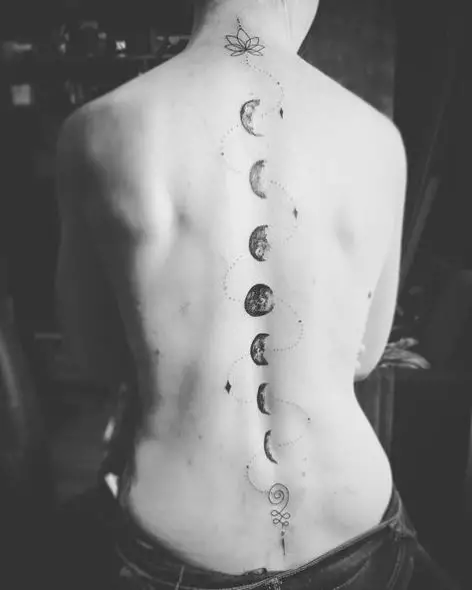Lotus Flower and Moon Phases Spine Tattoo
