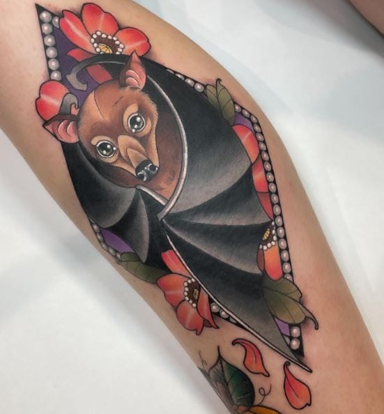 Colored Flowers and Bat Leg Tattoo