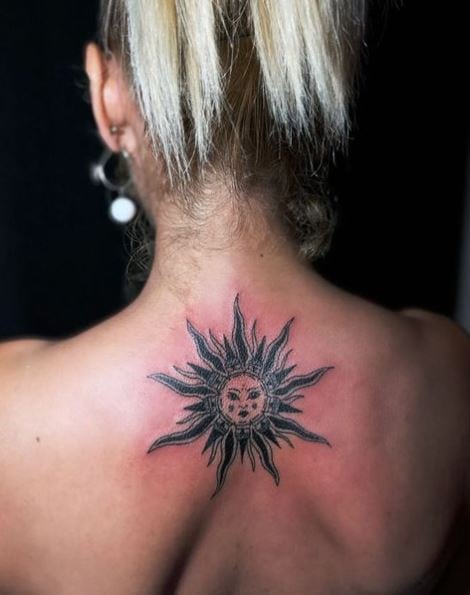 Black Sun with Face Spine Tattoo
