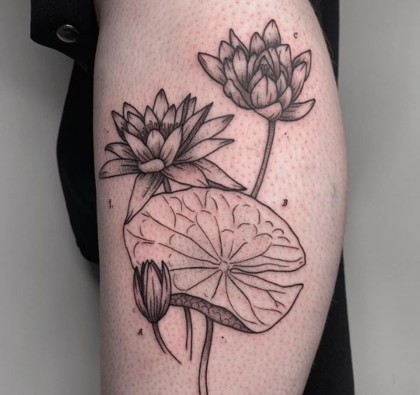 Black and Grey Traditional Water Lily Tattoo with Lily Pad