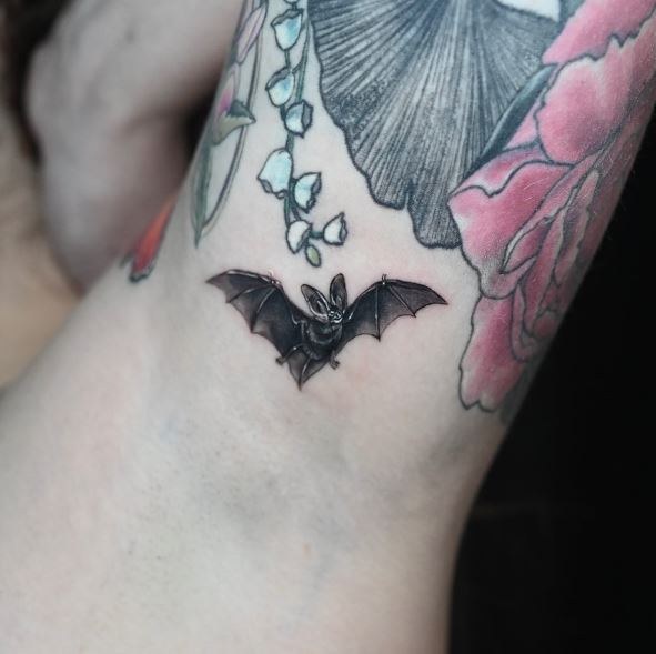 Black Minimalistic Bat Arm Tattoo