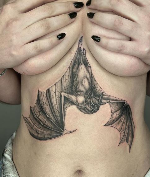 Grey Flying Bat below Breasts Tattoo