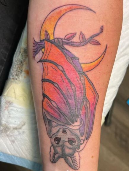 Colorful Bat Hanging from Branch Tattoo