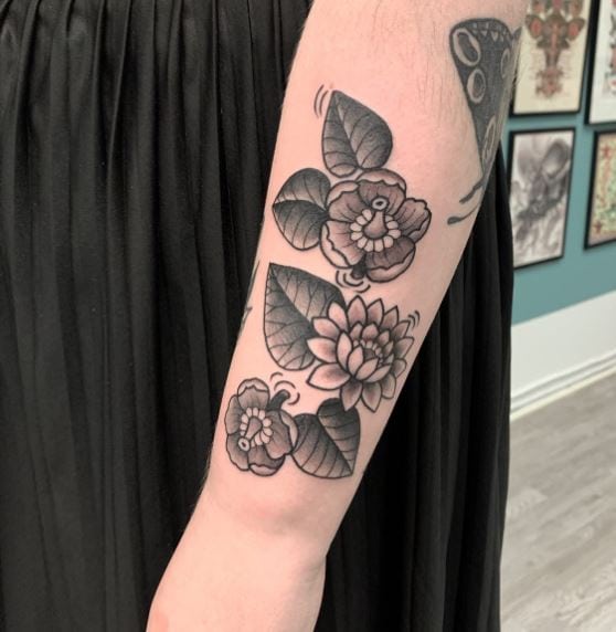 Bouquet of Grey Water Lilies with Leaves Arm Tattoo