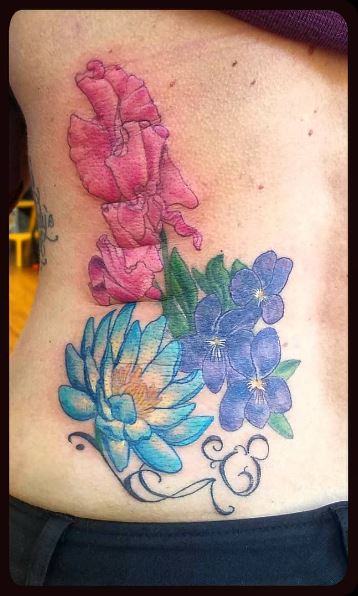 Colorful Water Lily Bouquet Ribs Tattoo