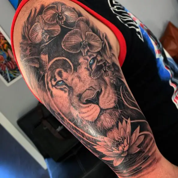 Blue Eyed Lion and Water Lilies Arm Tattoo