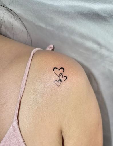 Black Triple Hearts Tattoo On Shoulder